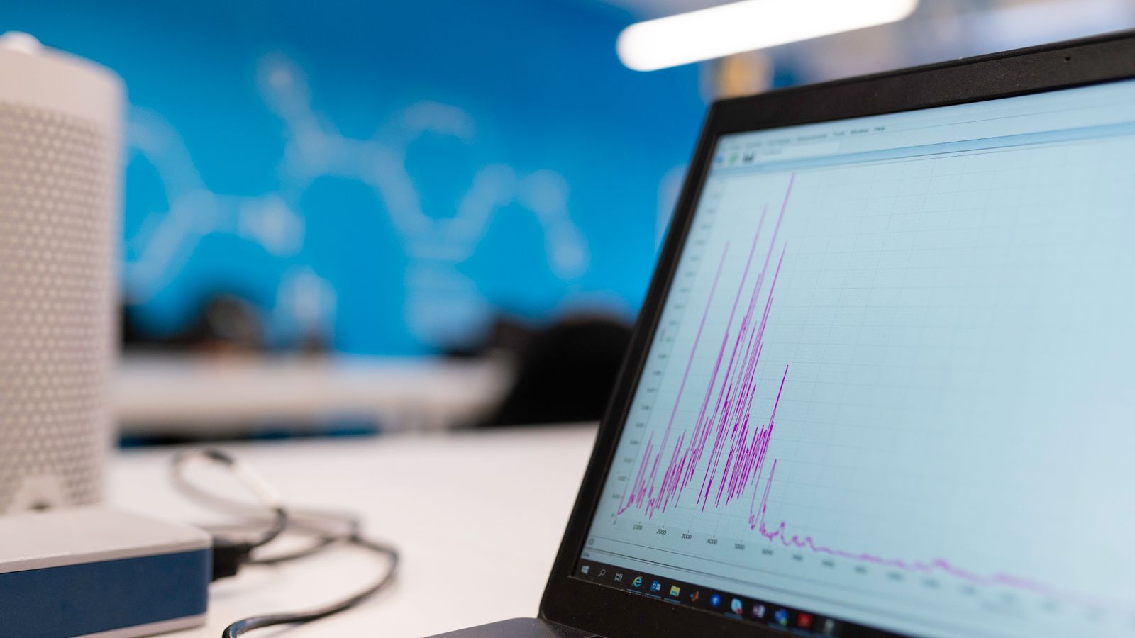 Laptop displaying a performance graph in an office workspace.