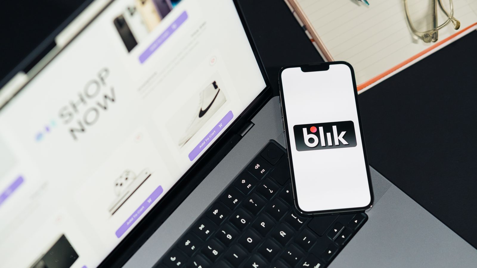 Laptop and smartphone displaying online shopping pages.