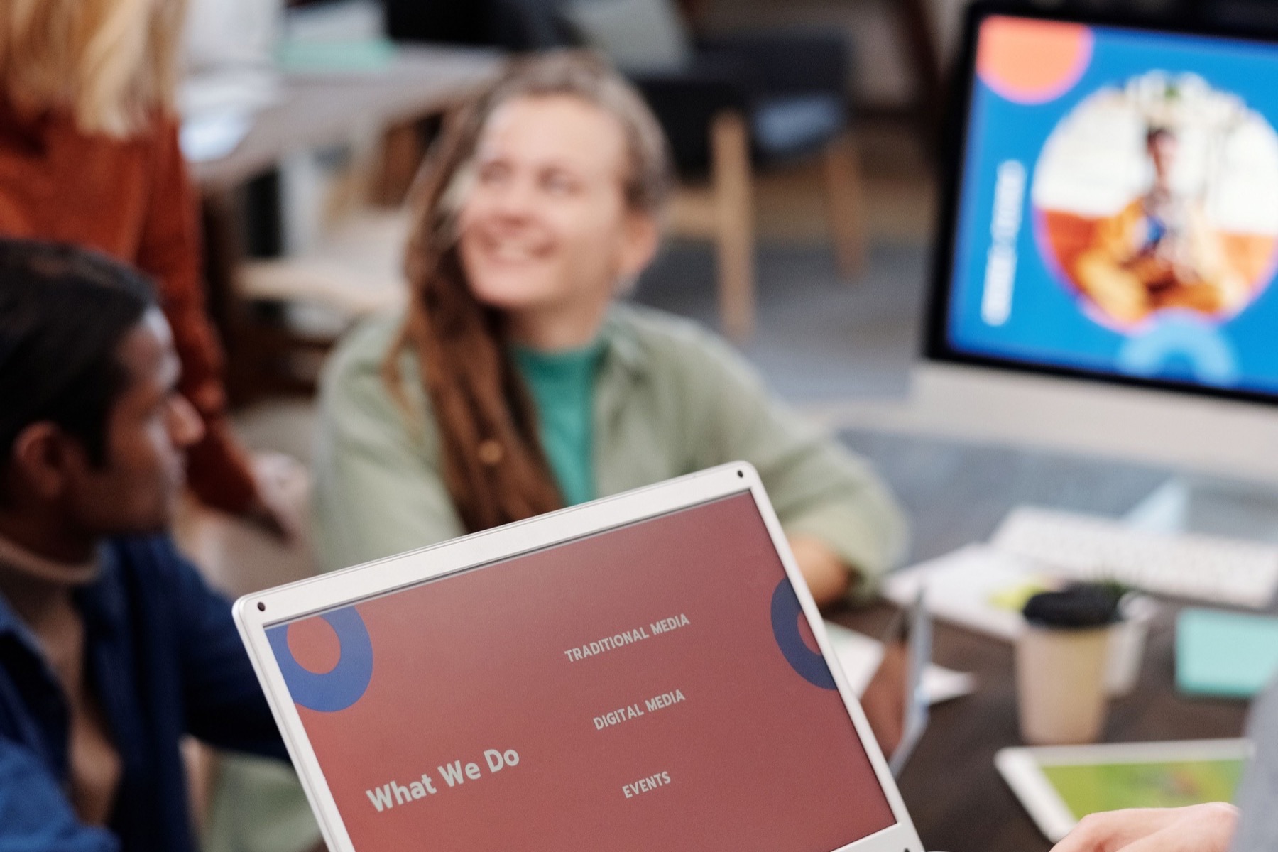 Marketing team reviewing a digital campaign plan on a laptop.